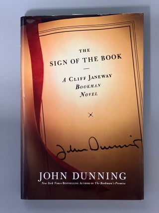 Item #10398 THE SIGN OF THE BOOK. John DUNNING